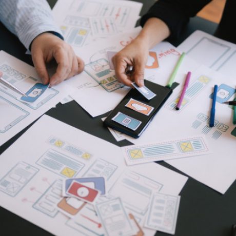 close-up-ui-ux-designer-meeting-web-smartphone-layout-application-prototype_40133-201